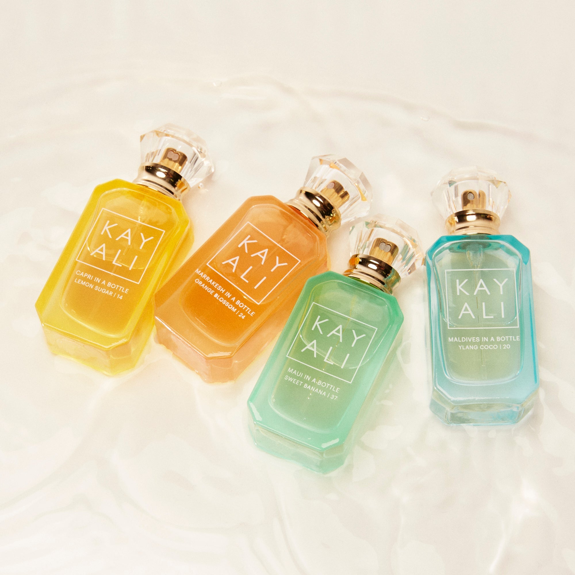 Four bottles of KAYALI perfume on a light background